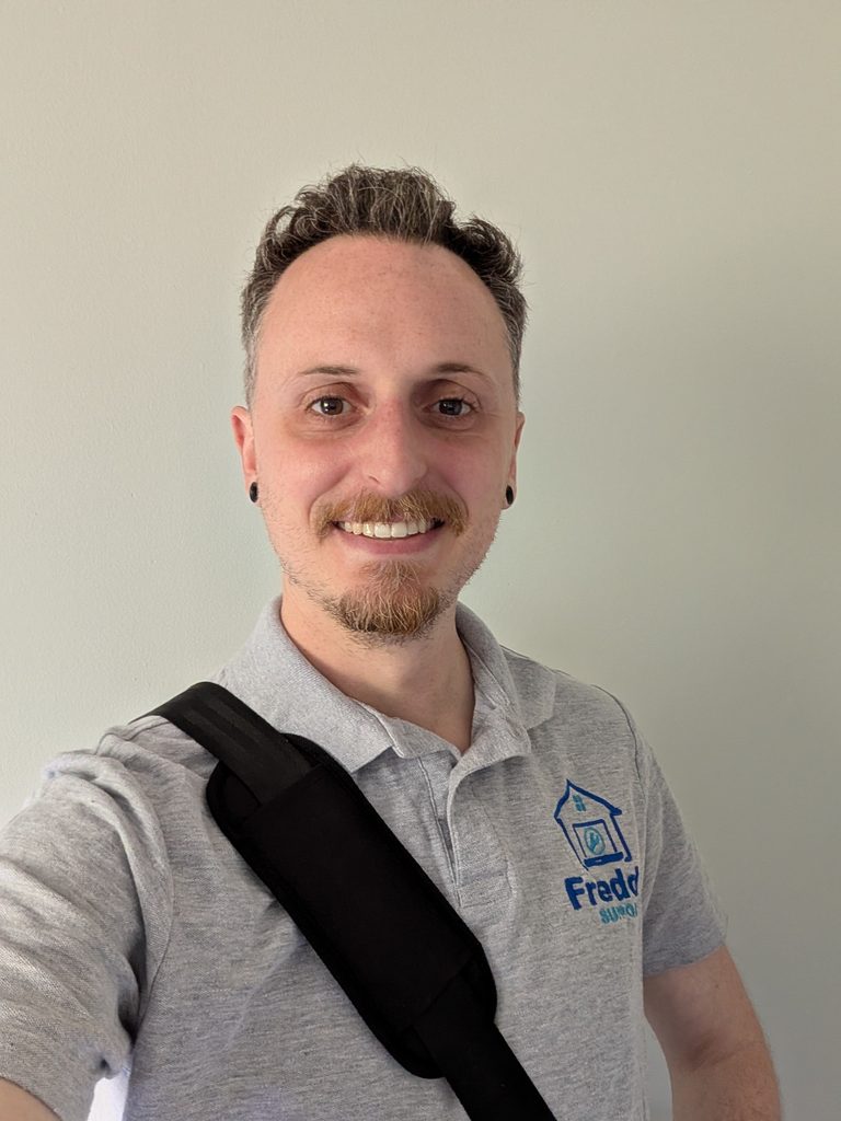 Jon, founder of Freddy Tech Support, wearing a Freddy Support polo shirt